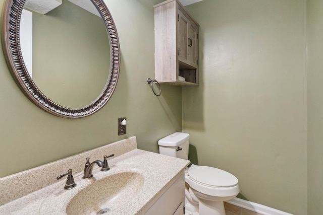 bathroom with toilet and vanity