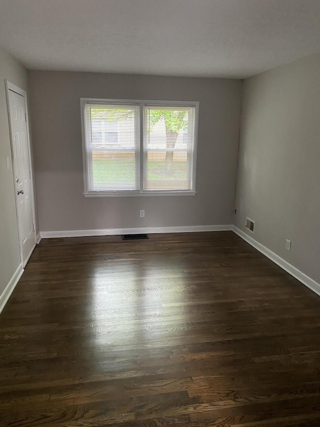933 N Broadway Unit 2, Lexington, KY 40505 - empty room featuring dark wood finished floors, visible vents, and baseboards
