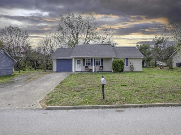 113 Woodland Trl, Somerset, KY 42501 - ranch-style house featuring driveway, covered porch, a garage, and a yard
