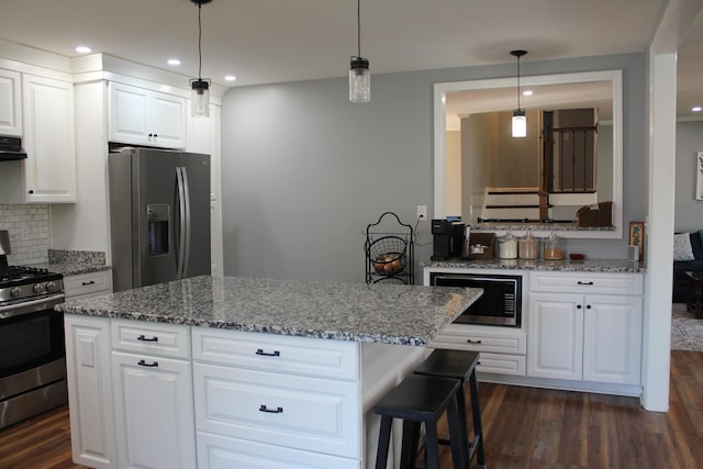 kitchen with dark wood-style flooring, gas stove, stone counters, built in microwave, and fridge with ice dispenser