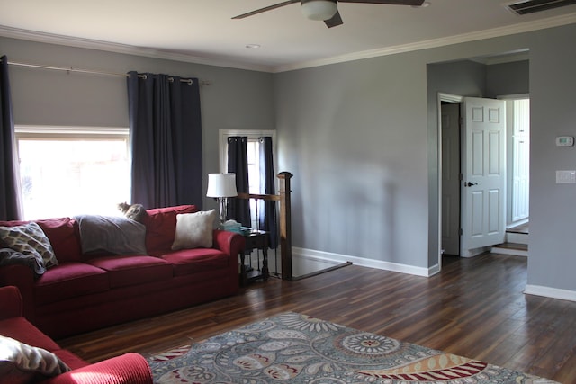 living room with visible vents, crown molding, ceiling fan, and dark wood-type flooring