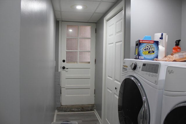 washroom featuring washer and dryer, wood finished floors, and laundry area