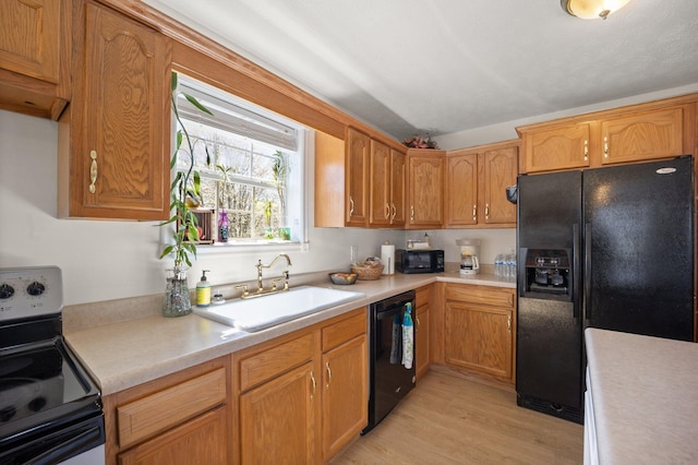 58 Mcclendon Ln, Russell Springs, KY 42642 - kitchen with black appliances, a sink, light countertops, light wood-style flooring, and vaulted ceiling