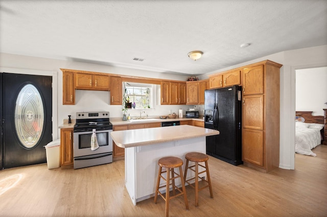 58 Mcclendon Ln, Russell Springs, KY 42642 - kitchen featuring black appliances, a sink, light wood finished floors, light countertops, and a textured ceiling