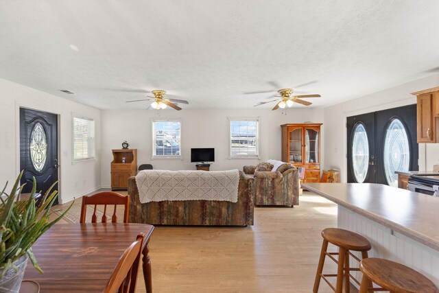 58 Mcclendon Ln, Russell Springs, KY 42642 - dining space featuring ceiling fan, light wood-type flooring, healthy amount of natural light, and a textured ceiling