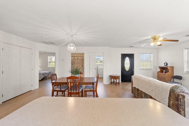 58 Mcclendon Ln, Russell Springs, KY 42642 - dining space featuring healthy amount of natural light, wood finished floors, ceiling fan, and a chandelier