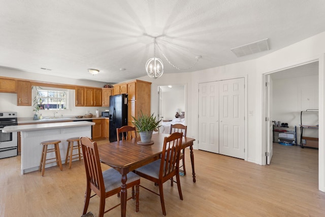 58 Mcclendon Ln, Russell Springs, KY 42642 - dining area with light wood-style flooring and a chandelier