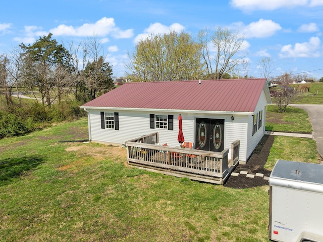 58 Mcclendon Ln, Russell Springs, KY 42642 - rear view of house featuring a deck, metal roof, and a yard