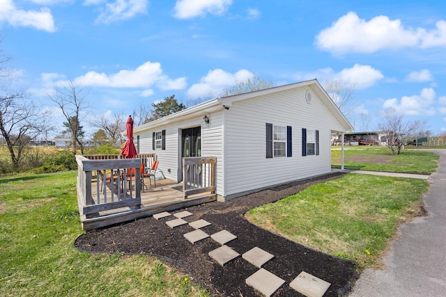 58 Mcclendon Ln, Russell Springs, KY 42642 - view of property exterior with a deck and a yard