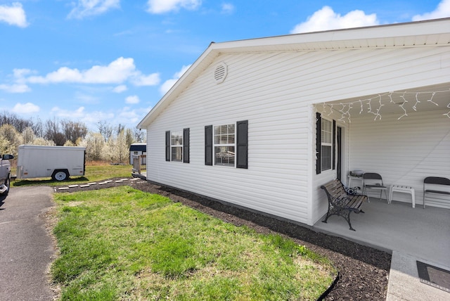 58 Mcclendon Ln, Russell Springs, KY 42642 - view of home's exterior with a lawn and a patio area