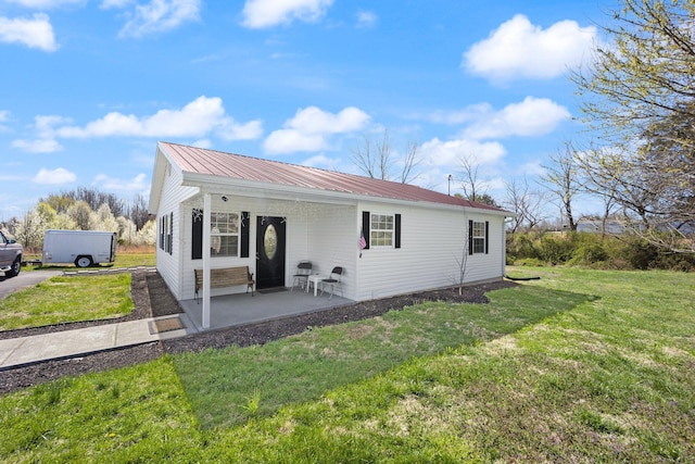 58 Mcclendon Ln, Russell Springs, KY 42642 - view of front of home featuring metal roof, a front yard, and a patio