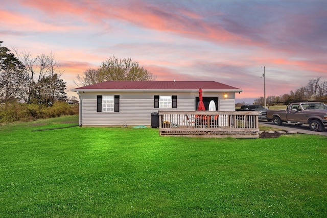 58 Mcclendon Ln, Russell Springs, KY 42642 - back of house at dusk featuring a deck, a lawn, and metal roof