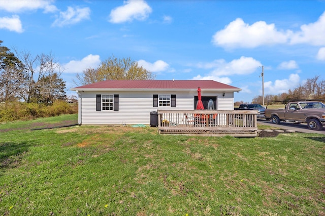 58 Mcclendon Ln, Russell Springs, KY 42642 - rear view of house featuring a wooden deck, metal roof, and a yard