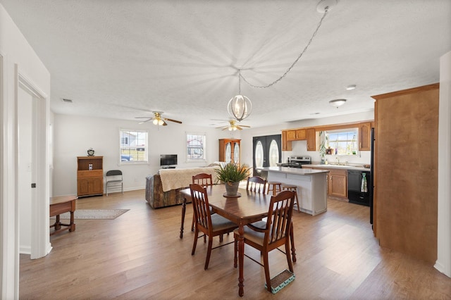 58 Mcclendon Ln, Russell Springs, KY 42642 - dining area featuring light wood-style floors, ceiling fan, a textured ceiling, and baseboards