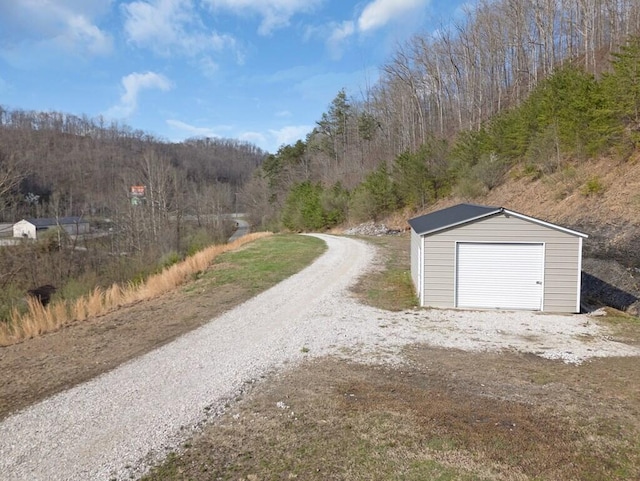 100 Mountain Enterprise Dr, Inez, KY 41224 - detached garage featuring driveway and a view of trees