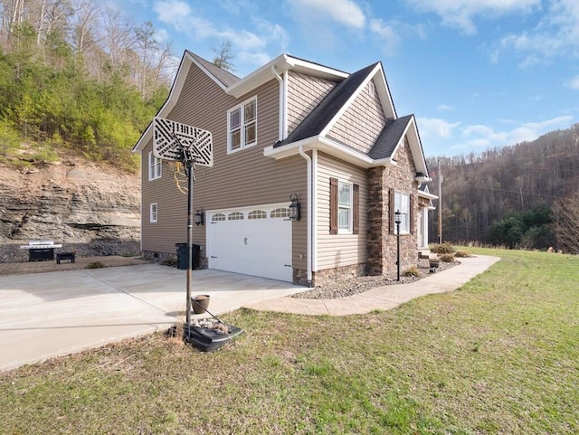100 Mountain Enterprise Dr, Inez, KY 41224 - view of home's exterior featuring stone siding, driveway, a garage, and a yard