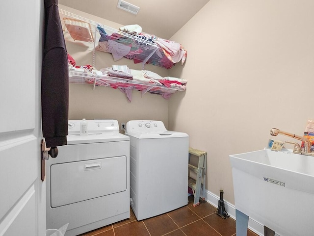 100 Mountain Enterprise Dr, Inez, KY 41224 - laundry room with dark tile patterned floors, washing machine and clothes dryer, a sink, visible vents, and laundry area