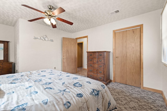 bedroom with baseboards, visible vents, a ceiling fan, and a textured ceiling