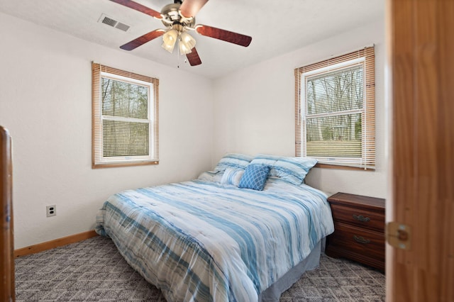 bedroom with baseboards, carpet floors, visible vents, and multiple windows