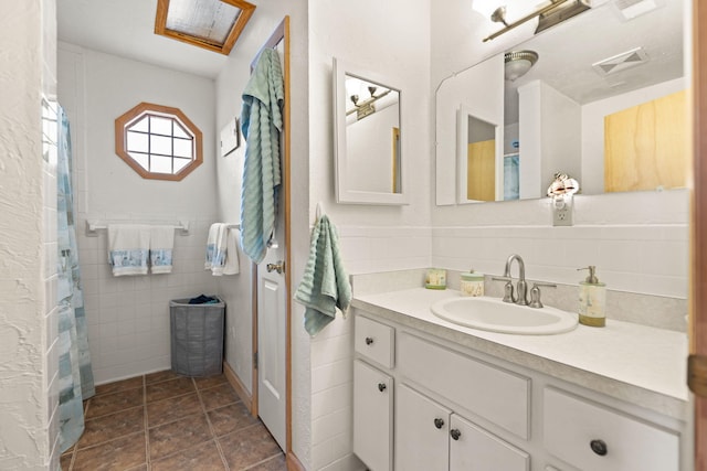 bathroom featuring tile walls, visible vents, vanity, and a shower with curtain