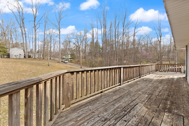 wooden terrace with a lawn
