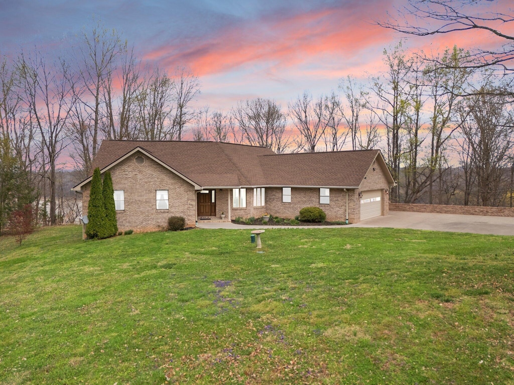 436 Green Hill Estates Rd, Monticello, KY 42633 - single story home featuring driveway, a front yard, roof with shingles, an attached garage, and brick siding