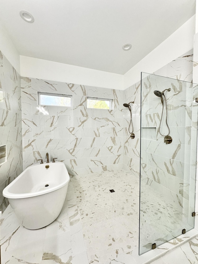 full bath with recessed lighting, marble finish floor, a freestanding tub, and walk in shower