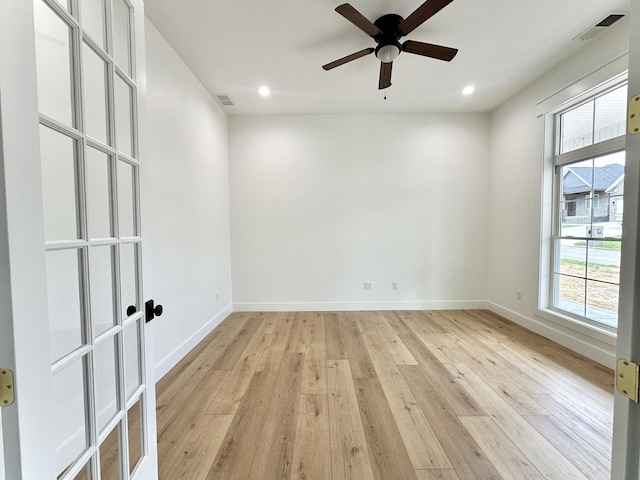 unfurnished room featuring visible vents, a healthy amount of sunlight, and light wood-type flooring