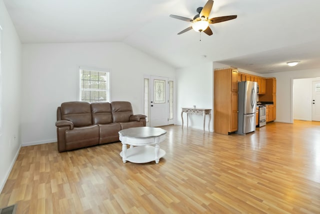 living room featuring lofted ceiling, light wood-style flooring, baseboards, visible vents, and ceiling fan