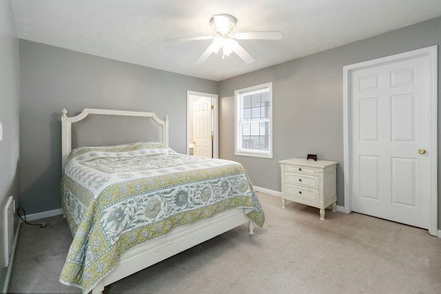 bedroom featuring a ceiling fan, baseboards, and light colored carpet