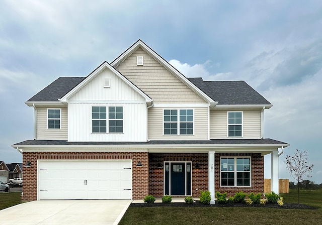 view of front of property with a front yard, board and batten siding, concrete driveway, and an attached garage