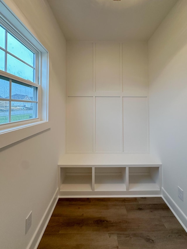 mudroom featuring dark wood-style flooring and baseboards