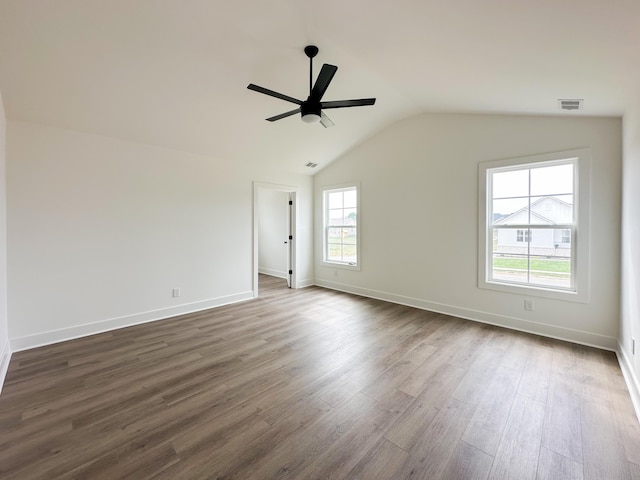 unfurnished room with dark wood finished floors, lofted ceiling, baseboards, visible vents, and ceiling fan