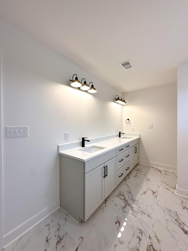 full bathroom featuring marble finish floor, a sink, and visible vents