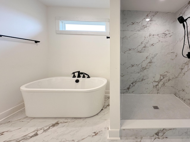 bathroom featuring marble finish floor, baseboards, a soaking tub, and a marble finish shower