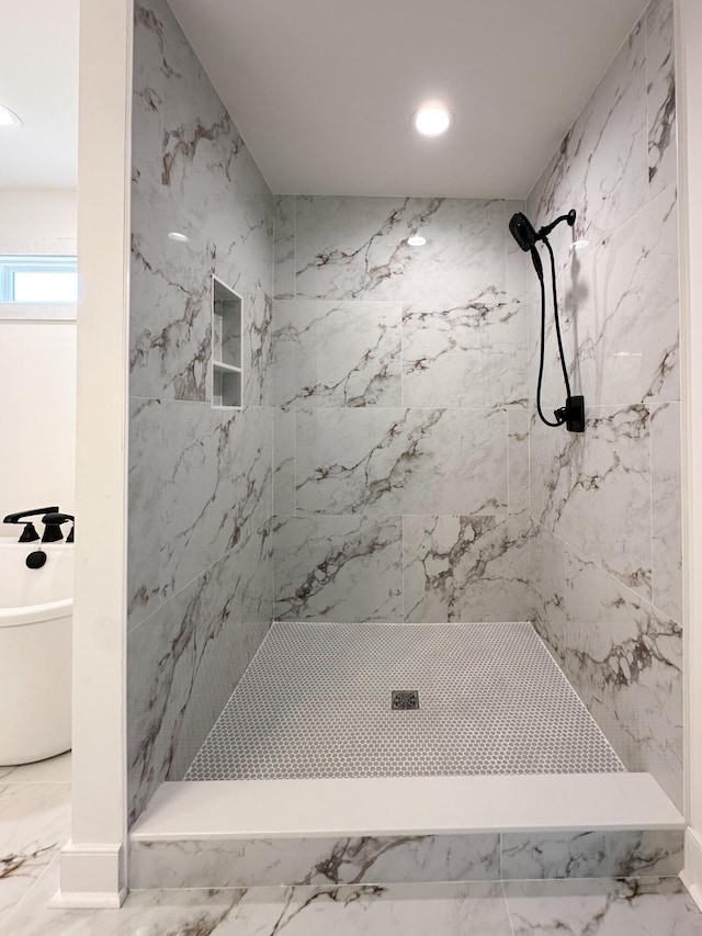 full bath featuring marble finish floor, a freestanding bath, a marble finish shower, and recessed lighting