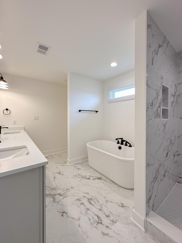 full bathroom featuring a soaking tub, walk in shower, baseboards, marble finish floor, and a sink