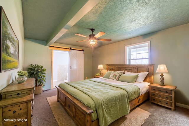 bedroom featuring a barn door, a textured ceiling, ceiling fan, and carpet flooring