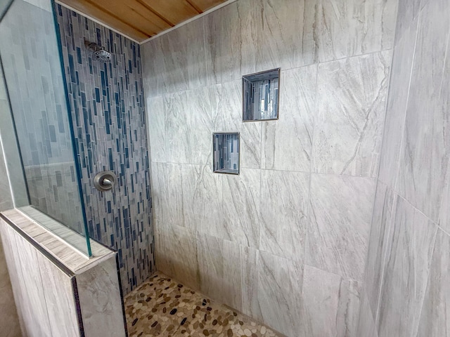 full bath featuring a tile shower