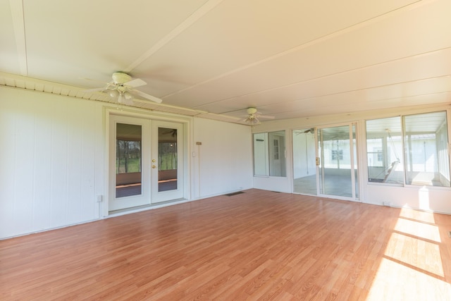 unfurnished sunroom with french doors and a ceiling fan