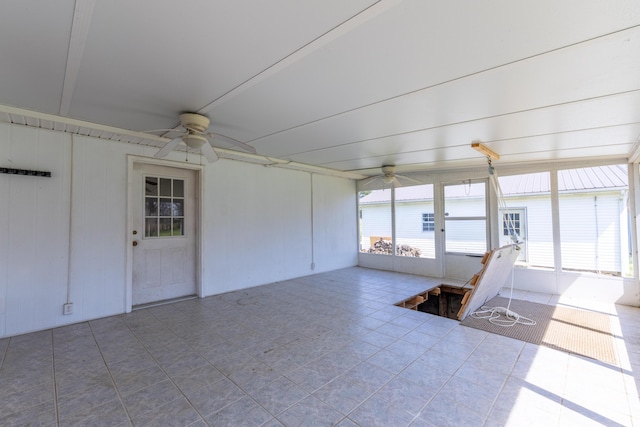 unfurnished sunroom with ceiling fan and a wealth of natural light