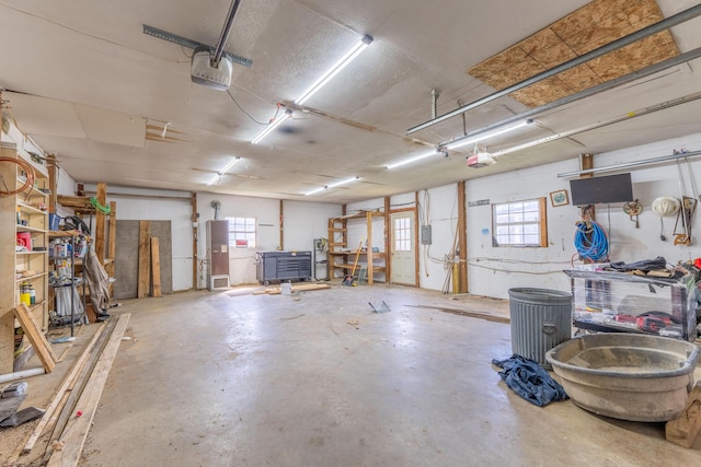 garage with water heater and a garage door opener