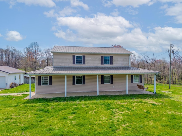 view of front of house featuring a front lawn, metal roof, and a patio area
