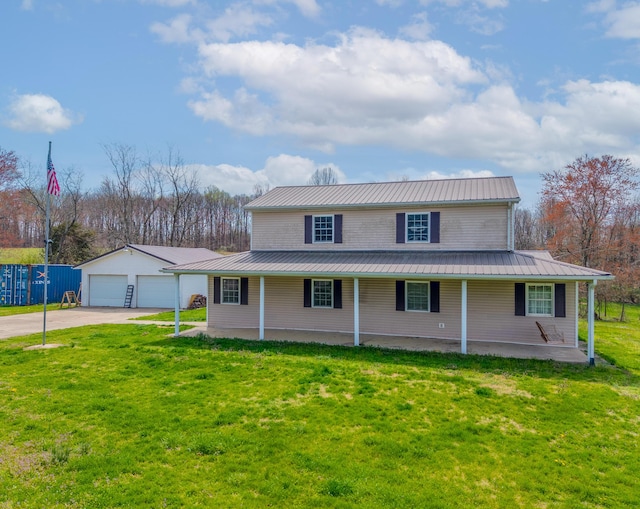 farmhouse inspired home with an outbuilding, a front yard, a detached garage, and metal roof