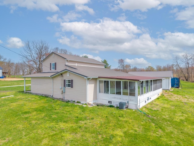 back of property featuring cooling unit, a sunroom, metal roof, crawl space, and a yard