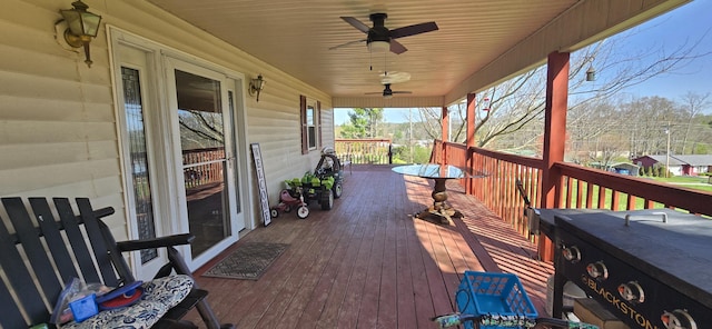 wooden deck featuring a ceiling fan