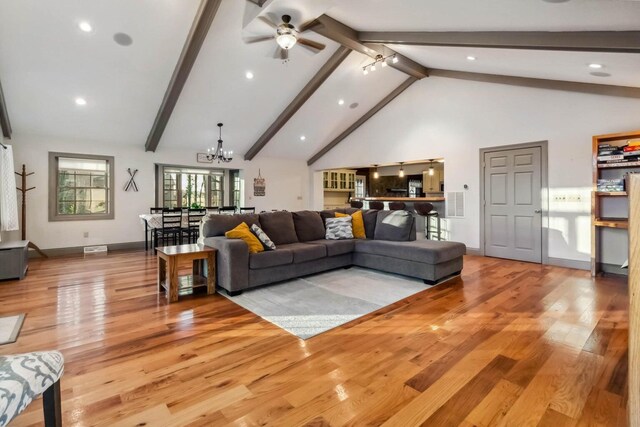 675 Indian Cave Subdivision Rd, Monticello, KY 42633 - living area with light wood-style floors, a chandelier, beamed ceiling, a ceiling fan, and high vaulted ceiling