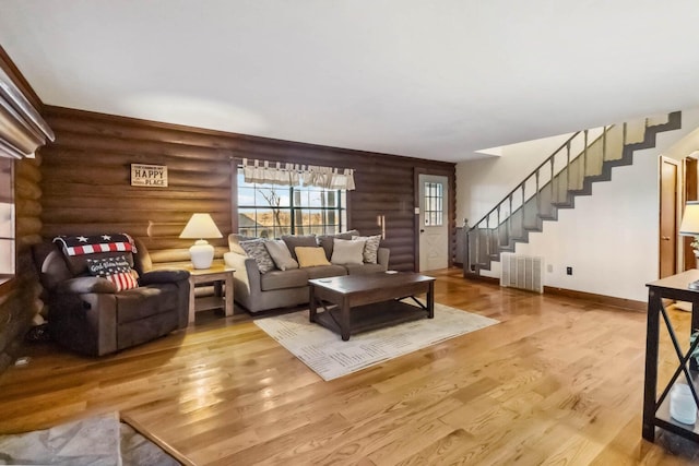 675 Indian Cave Subdivision Rd, Monticello, KY 42633 - living room featuring rustic walls, stairway, wood finished floors, and baseboards