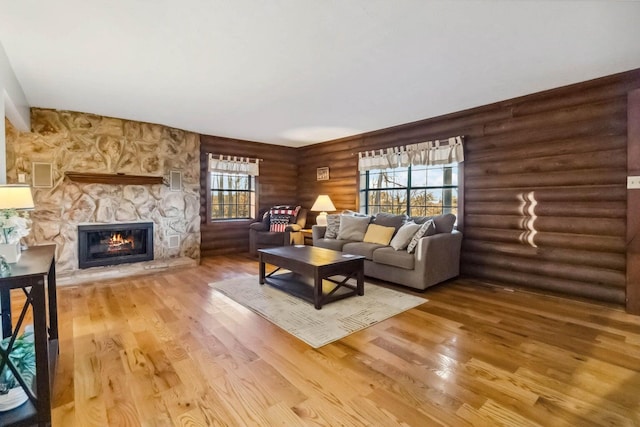 675 Indian Cave Subdivision Rd, Monticello, KY 42633 - living area with log walls, light wood-style floors, and a fireplace