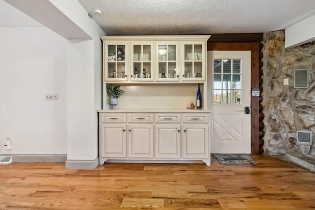 675 Indian Cave Subdivision Rd, Monticello, KY 42633 - doorway to outside featuring light wood finished floors and a textured ceiling